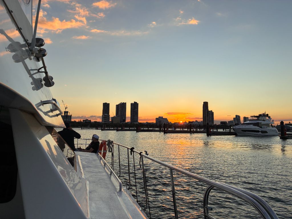 Guests on the deck of Cloud 9 Cruise catamaran enjoying the Gold Coast sunset over the Broadwater